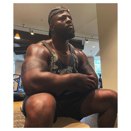 Winston Duke flexing his body